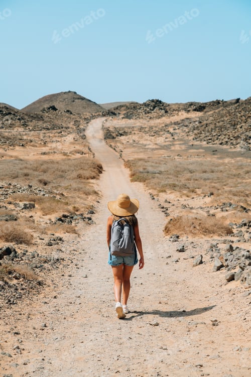 Preview: Traveler walking along mountain road