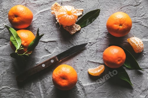 Preview: Citrus on table: mandarin, tangerine with a knife. Fresh organic juicy fruits