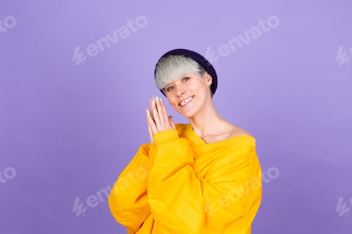 Preview: Stylish european woman on purple background happy sweet smile hands together
