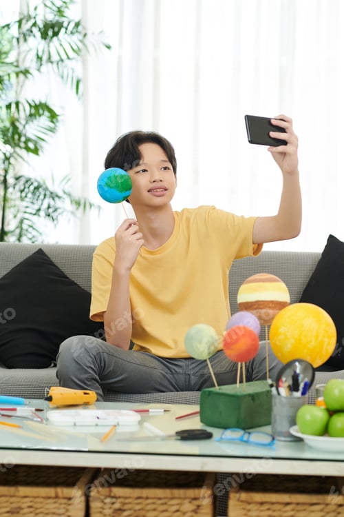 Preview: Boy Phototgraphing with Earth Styrofoam Model