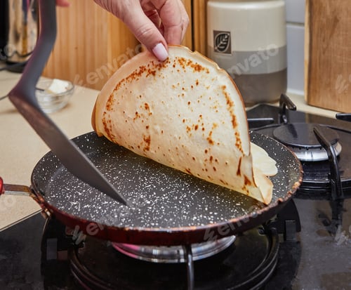 Preview: Cooking Crepe Suzette pancakes in frying pan on gas stove