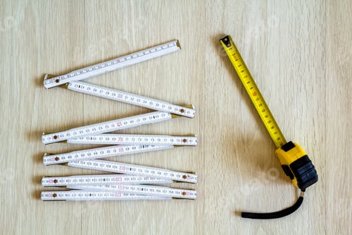 Preview: Measuring tape and meter on wooden background. Top view