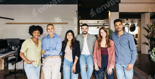 Preview: Diverse business team smiling at camera in office
