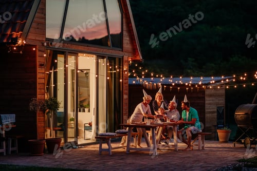 Preview: Happy family celebrating a birthday together outside