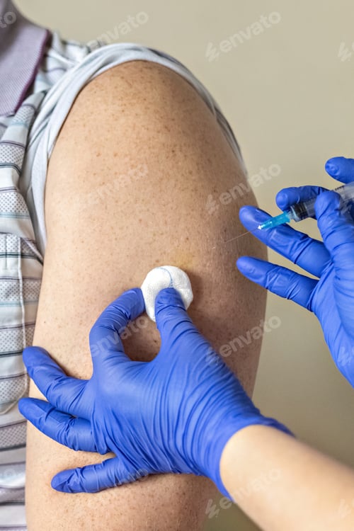 Preview: A doctor vaccinates a man against coronavirus at a clinic.The concept of vaccination.