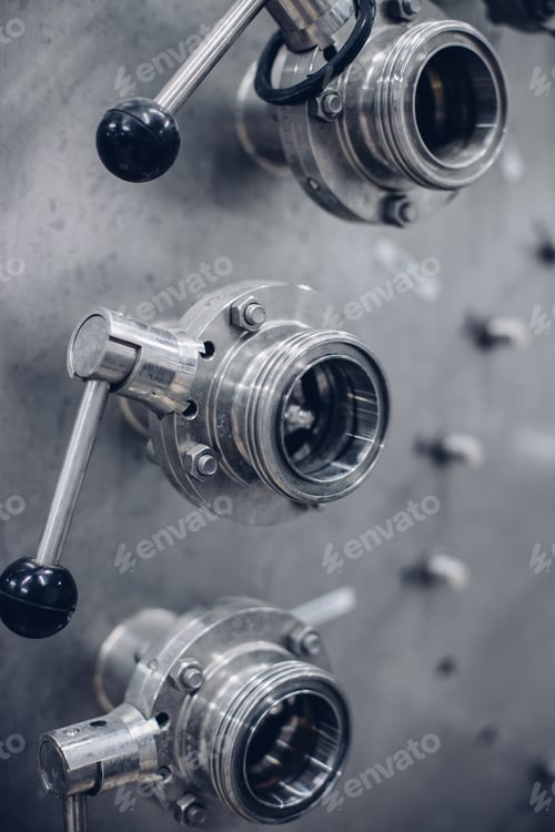 Preview: Vertical grayscale selective focus shot of stainless steel machine tools