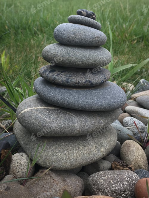 Preview: a pile of pebbles sit among some rocks on the ground