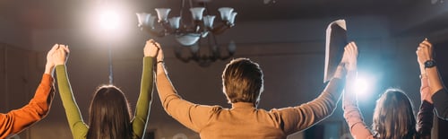Preview: panoramic shot of actors and actresses with hands up and dramatic lighting