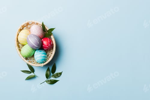 Preview: Multi colors Easter eggs in the woven basket on colored background