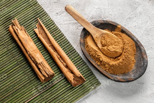 Preview: Cinnamon Sticks and Powder on Wooden Surface