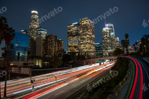 Preview: Scene of downtown Los Angeles at night, illuminated by the headlights of cars driving