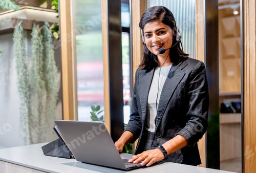 Preview: Portrait of Asian business woman wear headphone work with laptop look like customer service
