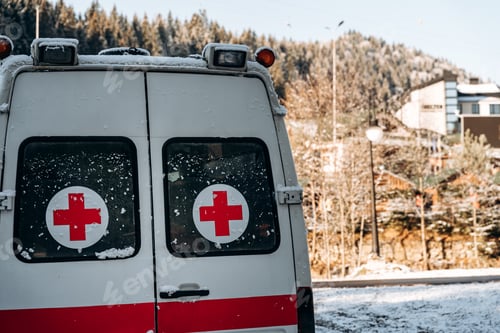 Preview: Ambulance standing at the snowy road at the village at the mountains