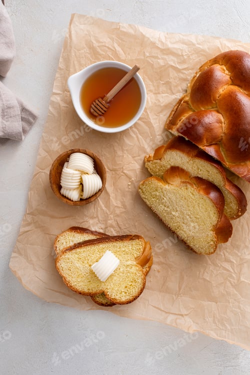 Preview: Freshly baked hallah sliced with butter and honey