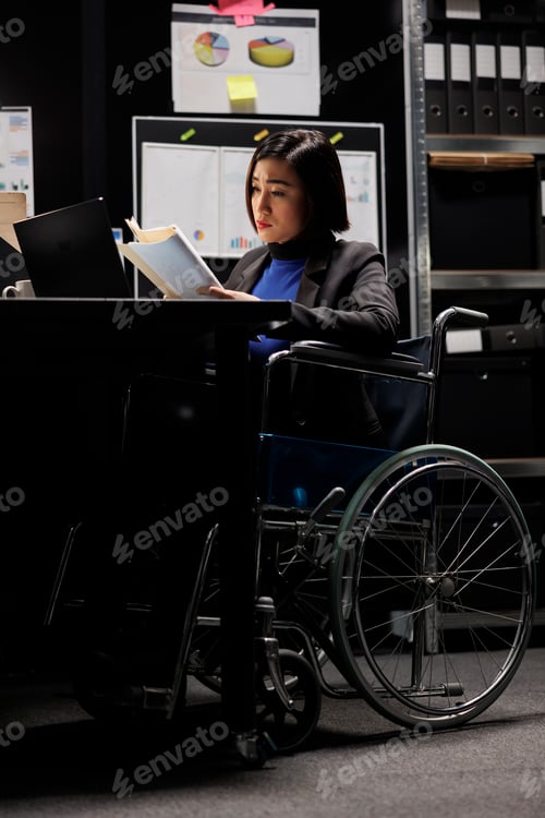 Preview: Accountant in wheelchair checking files