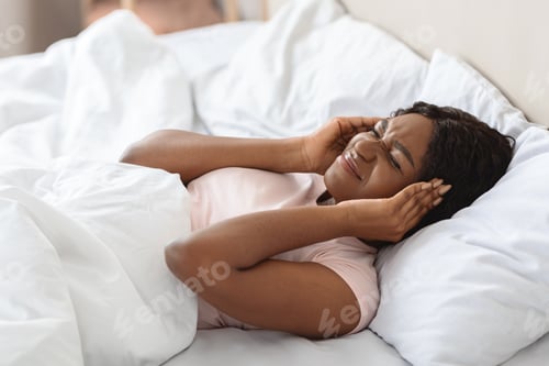 Preview: Annoyed black woman touching her head and keeping eyes closed