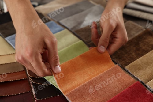 Preview: Man choosing fabric among different samples indoors, closeup