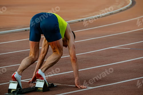 Preview: male runner in starting blocks sprint race