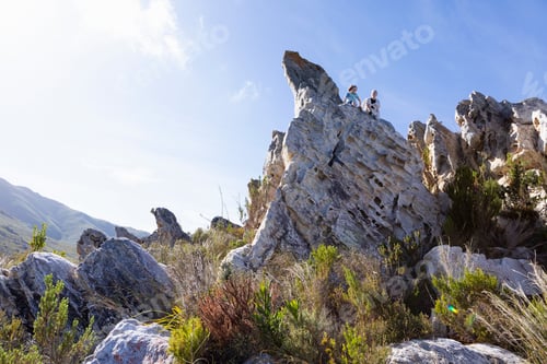 Preview: Two children climbing on top of large sandstone rock formations on a nature trail.