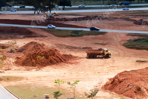Preview: A New road construction with cars passing by in the background