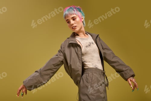 Preview: Young woman with colorful hair flaunting vibrant fashion in a creative studio