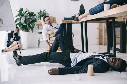 Preview: exhausted businesspeople sleeping in conference hall at office