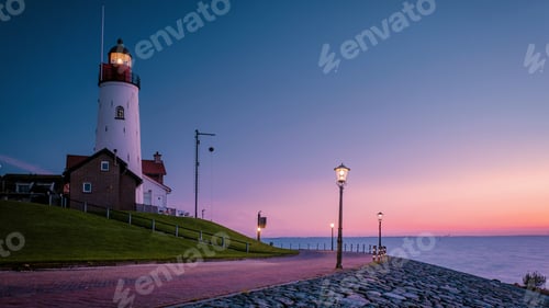 Preview: Urk Flevoland Netherlands sunset at the lighthouse and harbor of Urk Holland. Fishing village Urk