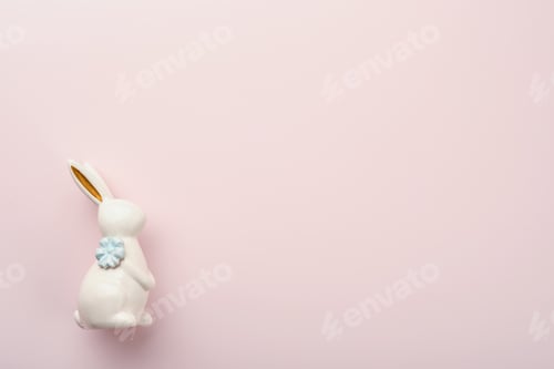 Preview: Happy Easter. Easter eggs and white rabbit decoration isolated on trendy pastel pink background with