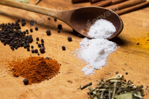 Preview: Spoon and heap of spices on the table