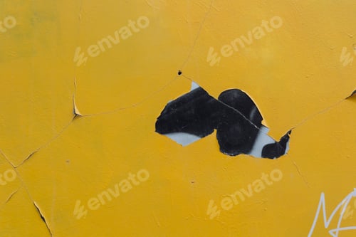 Preview: A yellow wall with a black and white graffiti on it