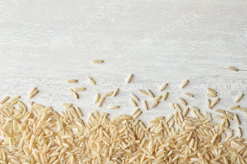 Preview: Brown rice on wooden background, top view with space for text
