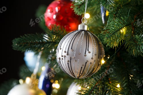 Preview: Christmas fir branches with decorations on a black background, copy space.