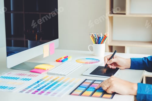 Preview: Graphic designer drawing on graphics tablet at workplace
