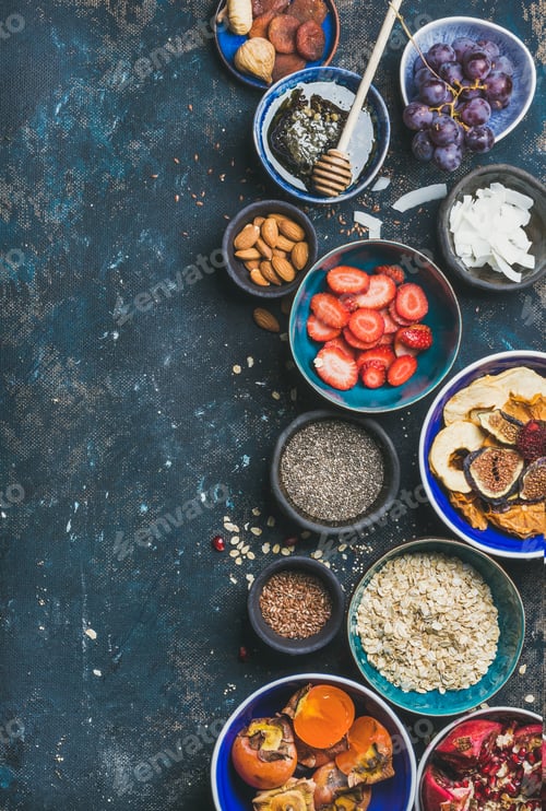 Preview: Ingredients for healthy breakfast in bowls over plywood background