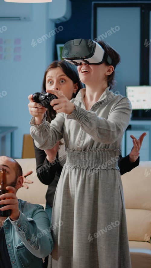 Preview: Woman using joystick and vr glasses while workmates cheering