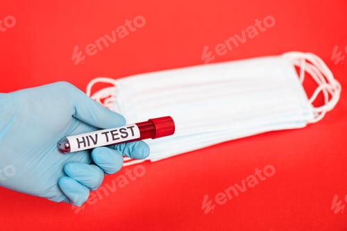 Preview: cropped view of scientist holding sample with hiv test lettering near medical masks isolated on red