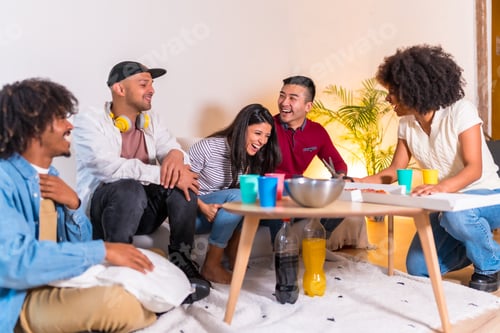 Preview: on a sofa eating pizza and drinking soft drinks at a home party, girl cutting the pizza and handing