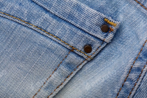 Preview: Denim Jeans Texture Background With Torn. The Texture Of The Colored Cotton Fabric. Stitched