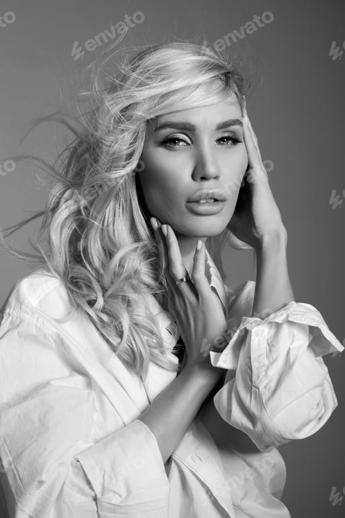 Preview: Blonde woman with hair flying in the wind, a close-up portrait of a girl in a white shirt, natural