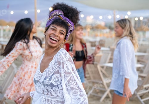 Preview: Attractive woman in stylish dress dancing on the beach