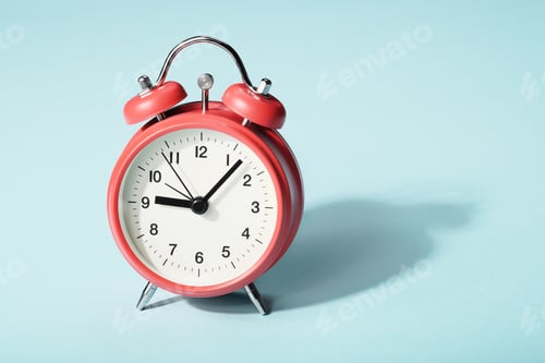 Preview: Red alarm clock with shadow on blue background. Seven minutes past nine on the clock
