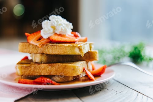 Preview: French toast topped with strawberries whipped cream
