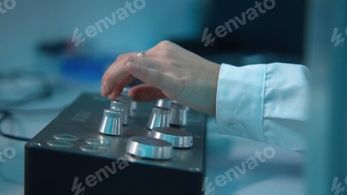 Preview: Close-up of woman rotating buttons on equipment control panel. Stock footage. Woman turns buttons on