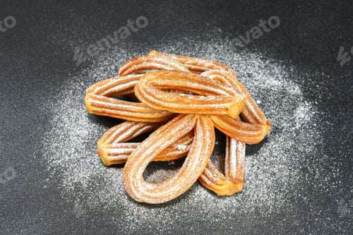Preview: Traditional Spanish Dessert Churros, Fried Dough Pastry Dusted With Powdered Sugar, Black Background