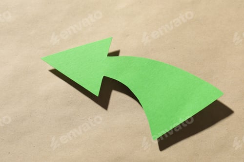 Preview: One green arrow on kraft background, closeup