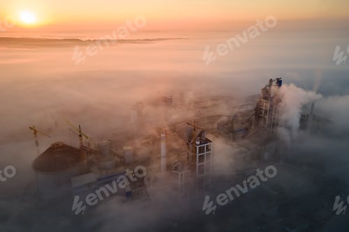 Preview: Aerial view of cement factory with high concrete plant structure and tower crane