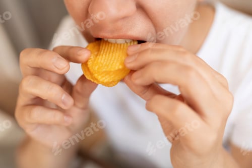 Preview: woman has cravings for junk food and eats chips