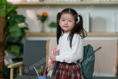 Preview: Confident child. Young girl with backpack and school supplies ready for class.