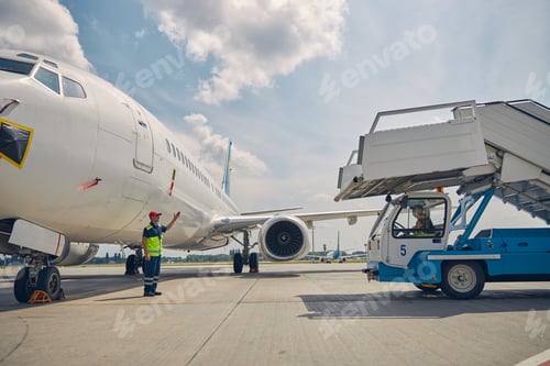 Preview: Experienced airport worker directing the ground vehicle operator