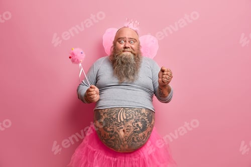 Preview: Emotional bearded daddy dresses like princess going on party raises clenched fist wears crown butter